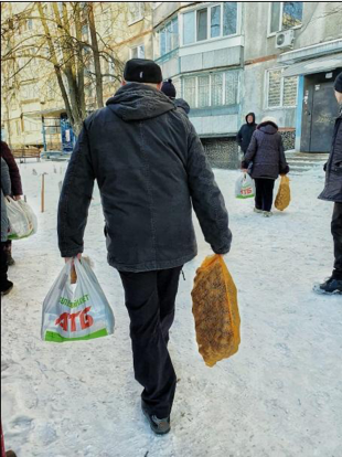 Man carries food in Ukraine