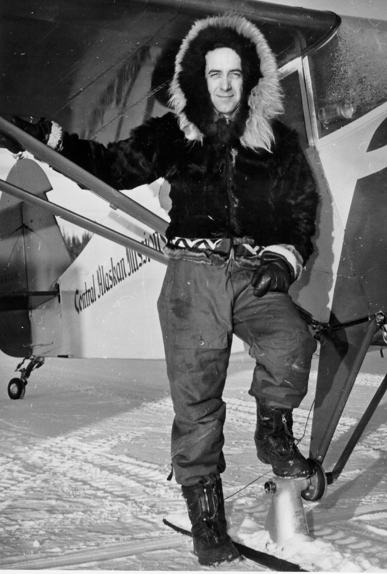 Black and white photo of man and a plane